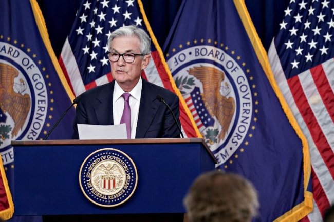 Federal Reserve officials agreed to hold interest rates steady after 10 consecutive increases but signaled that they were prepared to raise rates next month if the economy and inflation don't cool more.